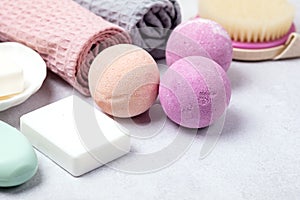 SPA Still Life Background Pink and Light Orange Bath Bombs Soaps Cosmetic Oil on Light Gray Background Washing Brush Gray and Pink