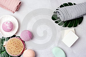 SPA Still Life Background Pink and Light Orange Bath Bombs Soaps Cosmetic Oil on Light Gray Background Washing Brush Gray and Pink