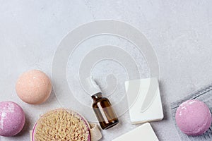 SPA Still Life Background Pink and Light Orange Bath Bombs Soaps Cosmetic Oil on Light Gray Background Washing Brush Gray Towel