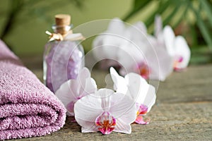 Spa still life with bath salt towel and orchids on wooden boards