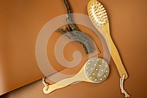 spa still life with brush. wooden brush for anticellulite massage on a brown table. still life, spa procedures