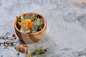 Spa still life with flowers in wooden bowl on light textured background, top view, close-up, selective focus