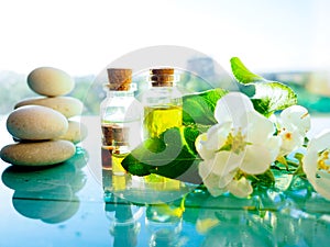 Spa still life with lavender oil and flowers on wooden table, on light background, aromatherapy essential oils in bottles