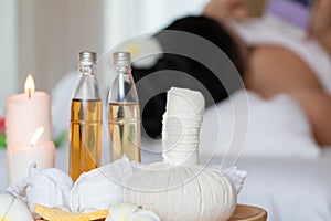 Spa still life with oil bottle, compress, aroma lotion and salt on wooden tray