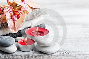 Spa still life with pebbles and red orange orchid