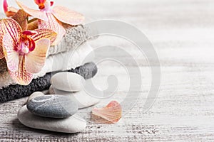 Spa still life with pebbles and red orange orchid