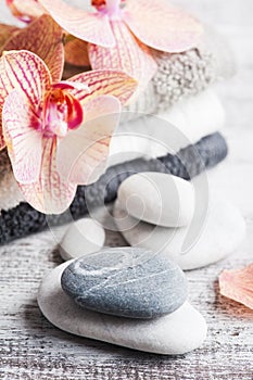 Spa still life with pebbles and red orange orchid