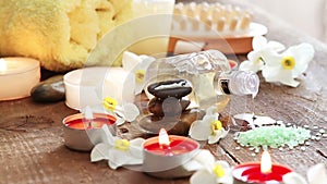 Spa still life of rocks, bath salt, massage oil and flowers