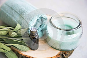 Spa still life set with candle and essential oil bottle