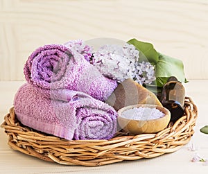 Spa still life with skincare products in a tray and lilac flower