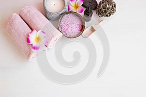 Spa still life top view with towels, bath salt and plumeria