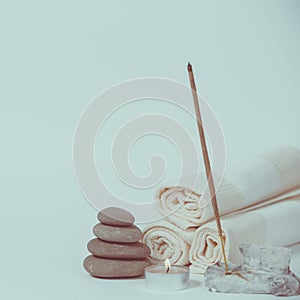 Spa still life with towels, stones, bath oil and candle