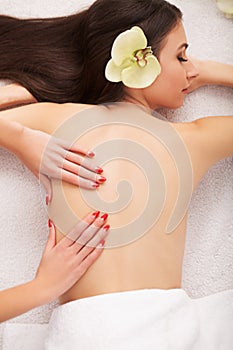 Spa Stone Massage. Beautiful Woman Getting Spa Hot Stones Massage in Spa Salon. Beauty Treatments Outdoor. Nature