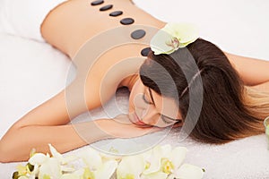 Spa Stone Massage. Beautiful Woman Getting Spa Hot Stones Massage in Spa Salon. Beauty Treatments Outdoor. Nature