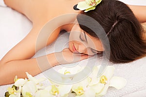 Spa Stone Massage. Beautiful Woman Getting Spa Hot Stones Massage in Spa Salon. Beauty Treatments Outdoor. Nature