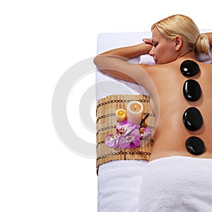 Spa Stone Massage. Blonde Woman Getting Stones Massage
