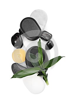 Spa stones, candle and bamboo leaves on white background, top view