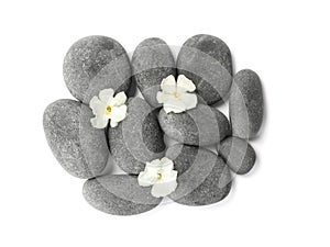 Spa stones and flowers on white background, top view