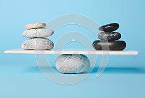 Spa stones on teeterboard against color background. Concept of balance photo