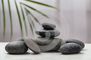 Spa stones on white table indoors. Zen and harmony