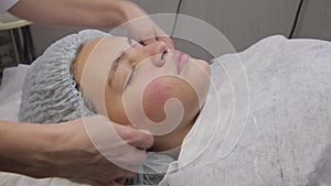 Spa teenager facial Massage. Face Massage in beauty spa salon. young girl with problem skin at the beautician. Body care