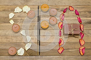 Spa text made of rose petal incense sticks candle and soap