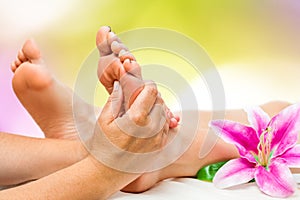 Spa therapist doing foot massage photo