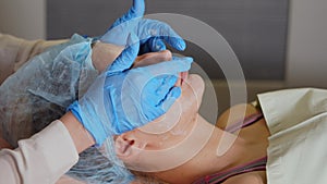 Spa therapy. Woman getting facial mask at beauty salon.