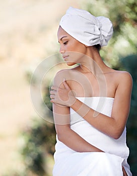 Spa, touch skin and woman in towel for beauty, healthy skincare and wellness outdoor. Relax, body and young person at