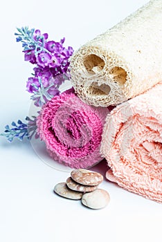 Spa towels rolls, flower and stones.