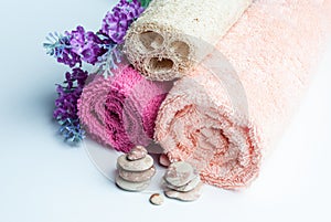 Spa towels rolls, flower and stones.