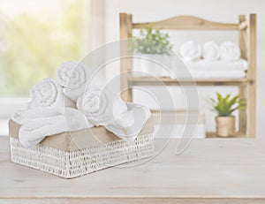 Spa towels on wood over abstract beauty salon room background