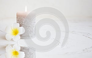 Spa tranquil setting with frangipani and candle