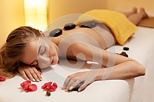 Spa Treatment. Beautiful Blonde Gets Stone Massage. Wellness Co