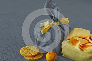 Spa treatment and body care concept in colors of the year 2021 - Illuminating yellow and ultimate grey. Present wrapped in