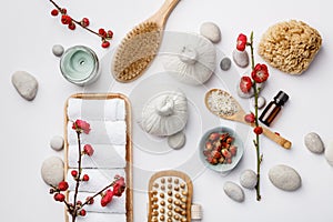 Spa treatment concept, flat lay composition with natural cosmetic products and massage brushes