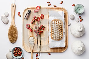 Spa treatment concept, flat lay composition with natural cosmetic products and massage brushes