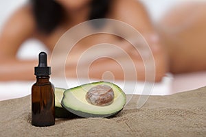 Spa treatment concept, massage using avocado oil.