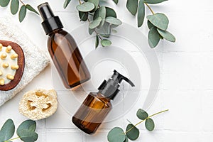 Spa treatment concept. natural spa cosmetics products with eucalyptus oil, massage brush, eucalyptus leaf