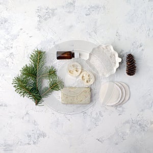 Spa treatment on light background. Spa accessories composition on white table. Natural aroma oil, sea salt, sisal, natural soap.