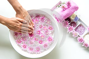 Spa treatment and product for female feet and manicure nails spa with pink flower, copy space,