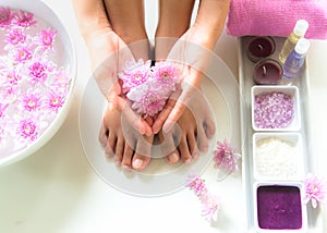 Spa treatment and product for female feet and manicure nails spa with pink flower, copy space,