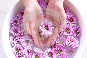 Spa treatment and product for female feet and manicure nails spa with pink flower, copy space, Thailand.