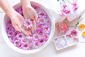 Spa treatment and product for female feet and manicure nails spa with pink flower for relax and healthy care.