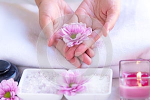 Spa treatment and product for female feet and manicure nails spa with pink flower and rock stone, copy space, select focus, Thaila