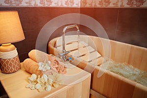 Spa treatment in the salon for relieving fatigue in a traditional folk style in a wooden bath with hydro massage