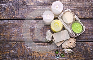 Spa treatment set on a wooden background - perfumed salt scented candles, natural soap .