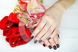 Spa treatment for woman hands with red flowers