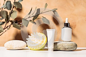 Spa treatments based on natural cosmetics. Made with mockup white cosmetic bottles and massager brush