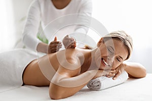 Spa Treatments. Beautiful Middle Aged Lady Enjoying Back Massage In Luxury Salon